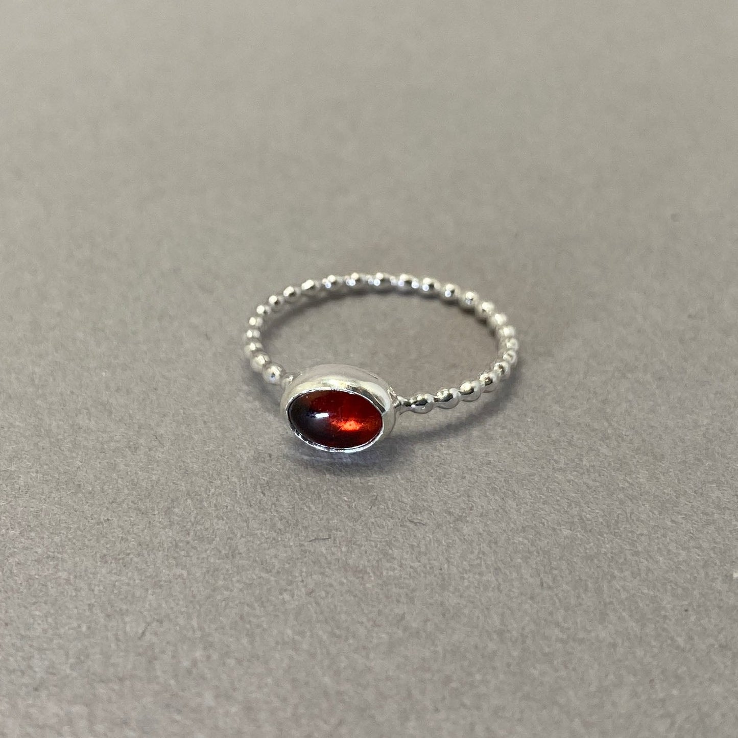 Red garnet gemstone ring with beaded sterling silver wire band