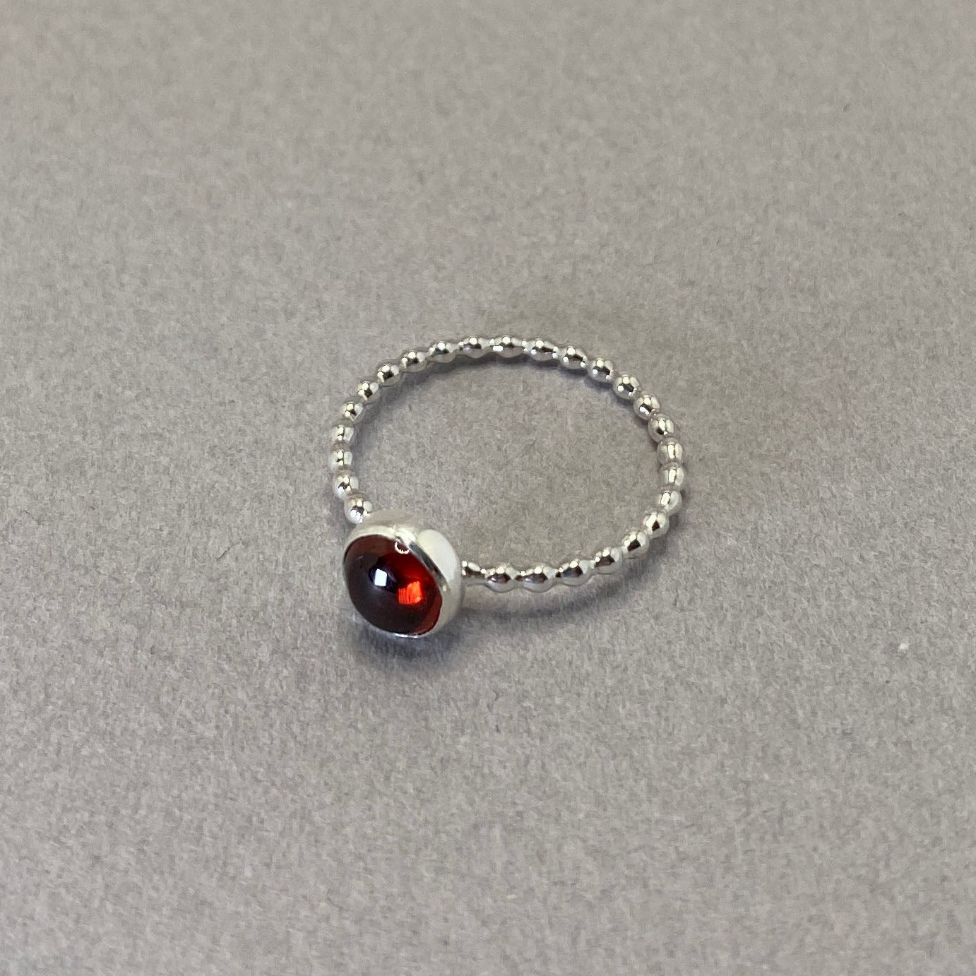 Red garnet gemstone ring with beaded sterling silver wire band